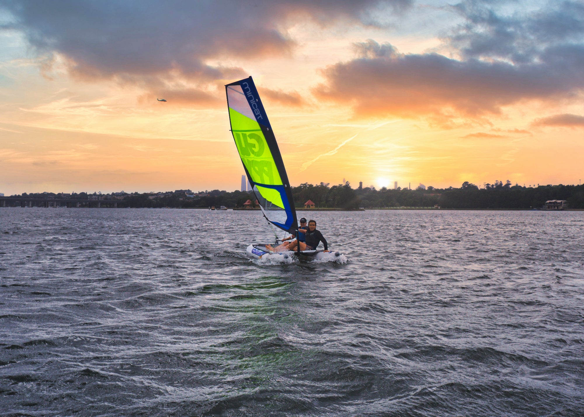 Sailboat dinghy MiniCat Guppy sailing in Sydney bay